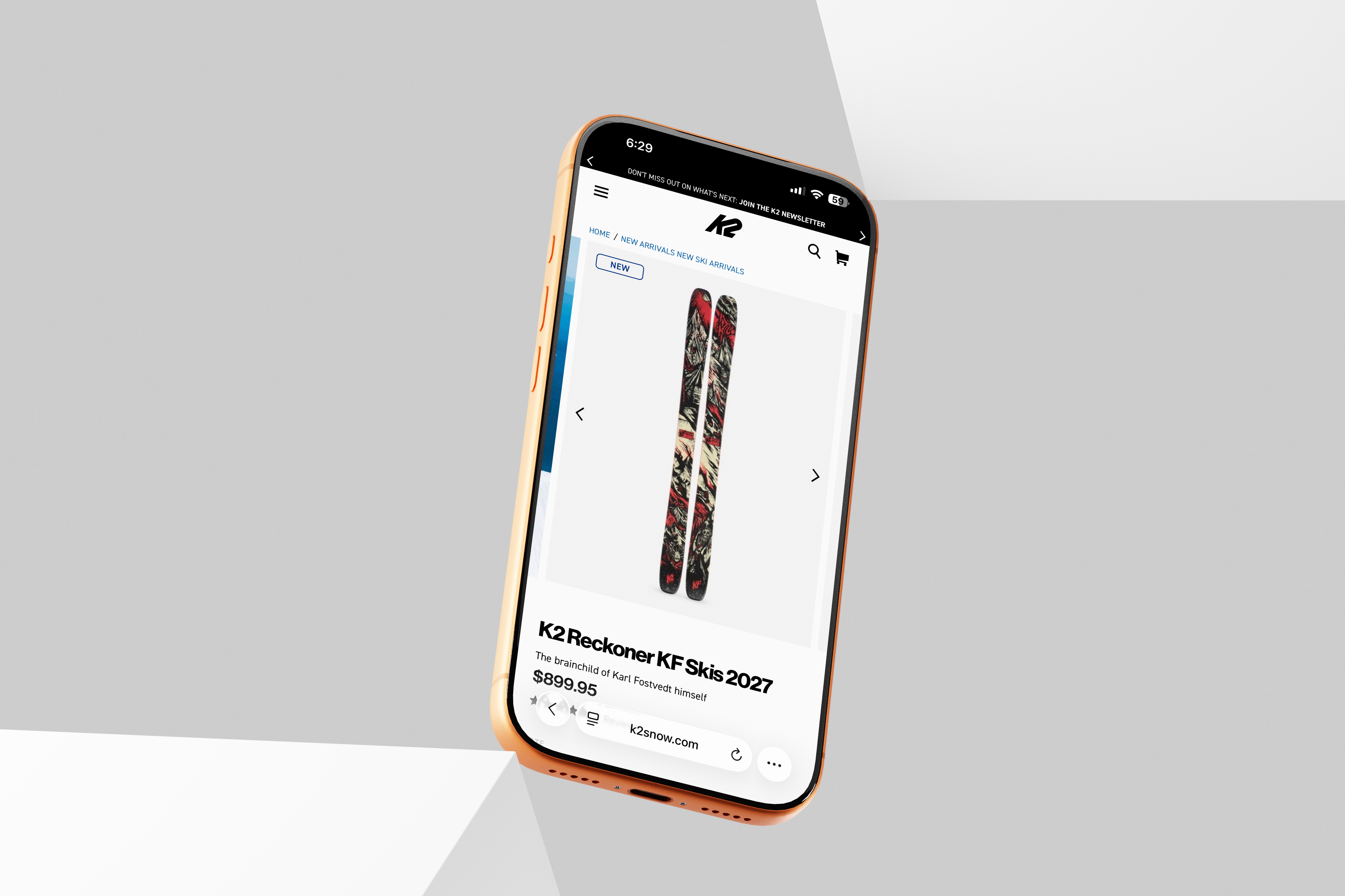 Angled orange iPhone displaying the K2 Reckoner KF skis product page